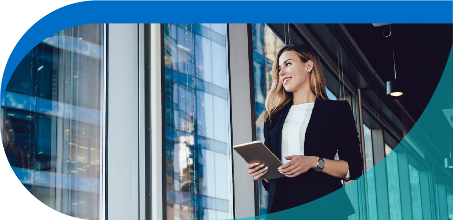 woman standing near the window holding a tablet